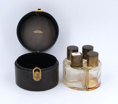 CARTIER. Quatre flacons de parfum de voyage en verre à bouch…