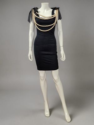 a mannequin dress with pearls and pearls on the shoulders