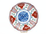 a red and white plate with blue flowers on it