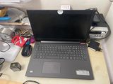 a laptop computer sitting on top of a wooden desk