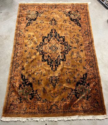 an antique persian rug on the floor in a living room