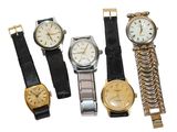 several different types of watches are displayed on a white surface