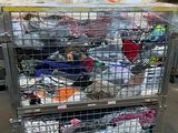 a metal cart with many items in it in a warehouse