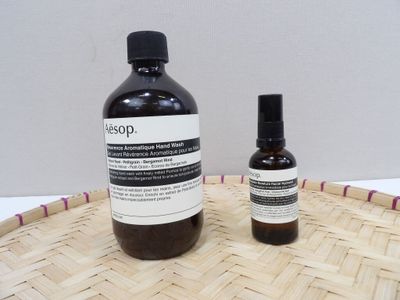 a bottle of liquid sitting next to a bottle of liquid on a basket