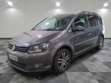 the volkswagen touran is parked in the garage on a checkered floor