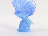 a blue glass bird that is sitting on a white surface