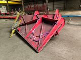 a red dumper sitting in the middle of a warehouse