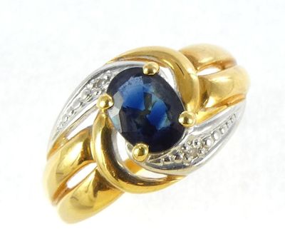 two tone gold and silver ring with a blue stone and diamonds