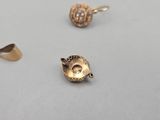 three different types of gold jewelry on a white surface