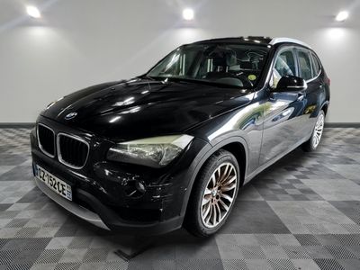 une photo d'un SUV BMW noir sur un sol à damier