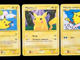 three pokemon cards are shown in a row on a black background