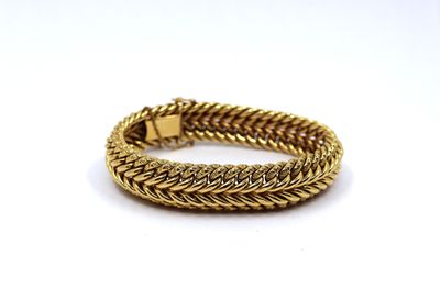 a gold bracelet on a white background