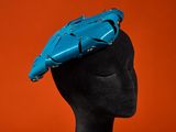 a close up of a mannequin head with a blue hat on it