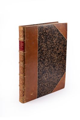 an old book with a brown leather cover on a white background