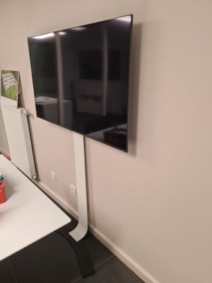un téléviseur à écran plat fixé au mur d'une pièce