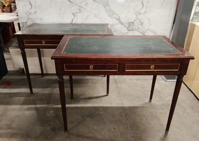 two tables with marble tops and drawers on them in a room