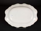 an image of a white plate sitting on top of a black table