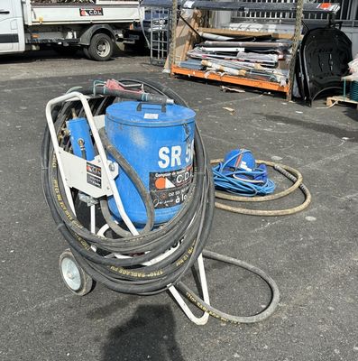 a blue machine that is sitting in the parking lot