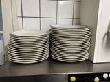 de nombreuses assiettes empilées sur le plan de travail de la cuisine