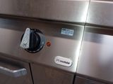 an image of a stainless steel oven with a knob on it