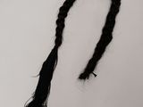 a black and white photograph of a long braided hair