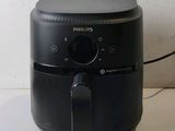 a black air fryer sitting on a counter top