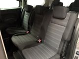 the back seats of a van with a black seat belt and a gray seat cover