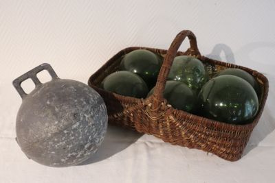 a basket of glass ornaments next to a metal ball