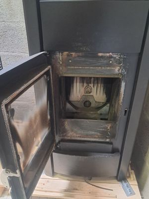 a small stove that is in the corner of a room