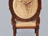 an old chair with a basket on the back of it