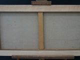 an easel with a wooden frame and a canvas on top of it