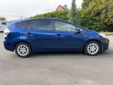 the blue toyota prius is parked in a parking lot