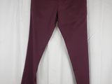 a close up of a pair of maroon pants hanging on a hanger