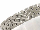 a close up of a silver bracelet on a white surface