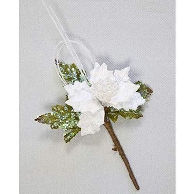 a close up of a flower on a stick on a table
