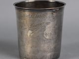 a silver cup that is sitting on a table