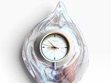 a clock that is sitting in the shape of a shell
