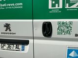 a green and white van with a qr code on the side