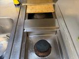 a metal stove top with a pot on top of it