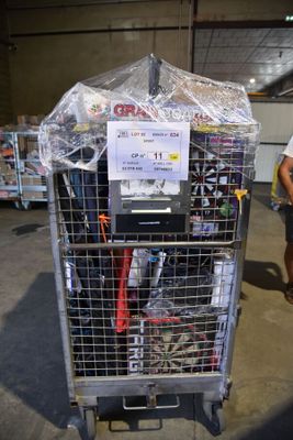 a man that is standing next to a cart full of stuff