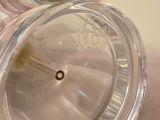 a clear glass vase with a small hole in it