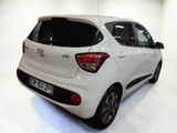 a white car that is parked in a white room