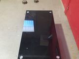 a black glass table with a blue screen on it
