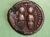 a close up of a coin with a man and a woman on it