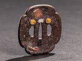 a small brown object on a table with a black background