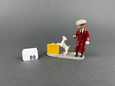 a small figurine of a man and a dog