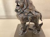 bronze statue of a man riding a horse with a dog on its back