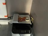 a toaster sitting on top of a toaster oven in the corner of a room