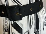 a dress with a belt and a button on it