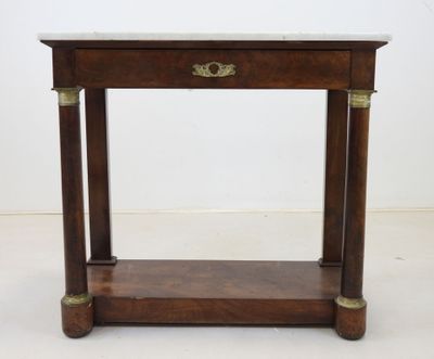 an old wooden table with a marble top and brass handles